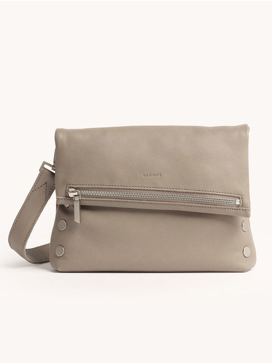 The Hammitt Los Angeles VIP Medium Clutch in pewter pebble leather features a wrist strap, front zipper pocket, silver hardware, and removable crossbody strap, shown against a plain light background.