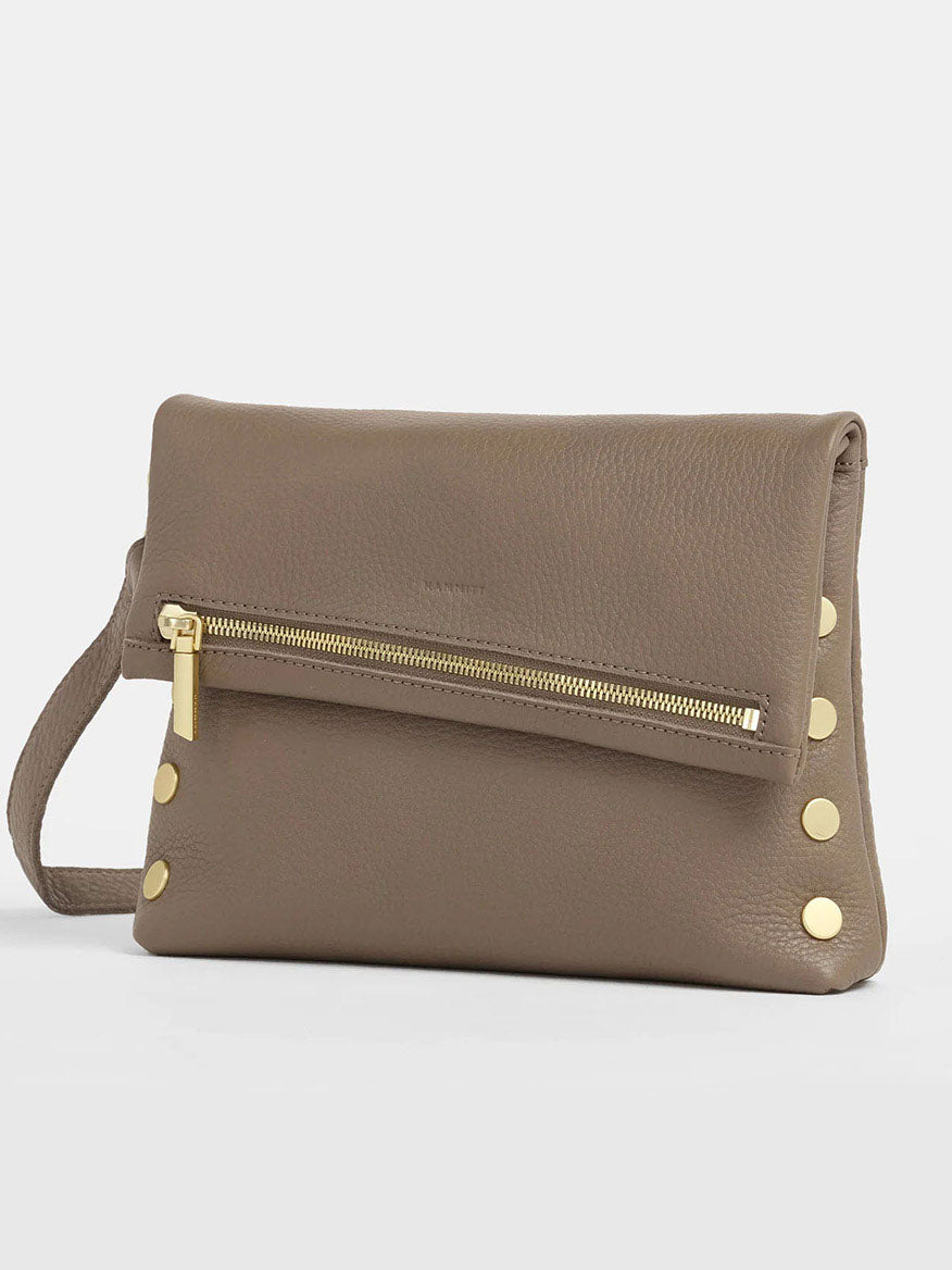 Explore the Hammitt Los Angeles VIP Medium Clutch in Sculpted Taupe, featuring a versatile wrist strap and sleek gold zipper. Accentuated by gold studs on the side, this clutch effortlessly transitions from day to night.