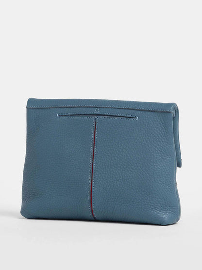 Introducing the Hammitt Los Angeles VIP Medium Clutch in Curated Blue: a textured leather accessory with a stitched vertical seam. Its elegant removable crossbody strap offers versatile style options, perfect against a crisp white backdrop.