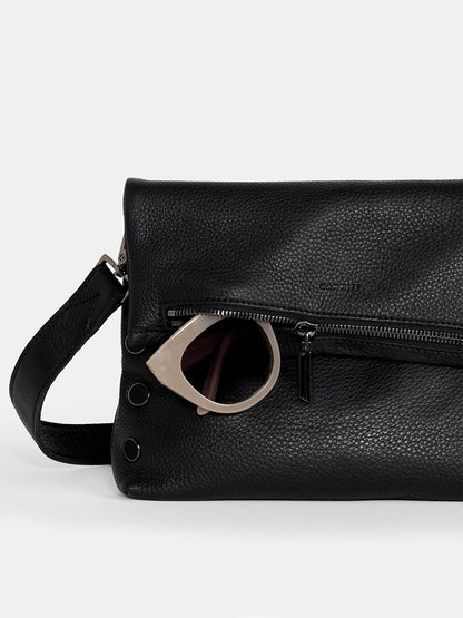 The Hammitt Los Angeles VIP Medium Clutch in black showcases a versatile design with pebbled leather, a zip pocket that holds sunglasses partially visible, and an adjustable crossbody strap for convenience.