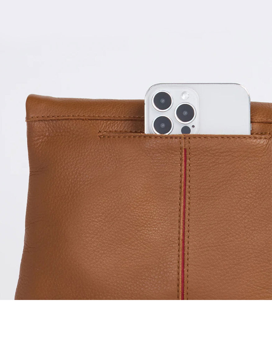 A silver smartphone with a quad camera setup is partially inserted into the Hammitt Los Angeles VIP Medium Clutch in Mahogany Pebble, which is adorned with brushed gold rivets.