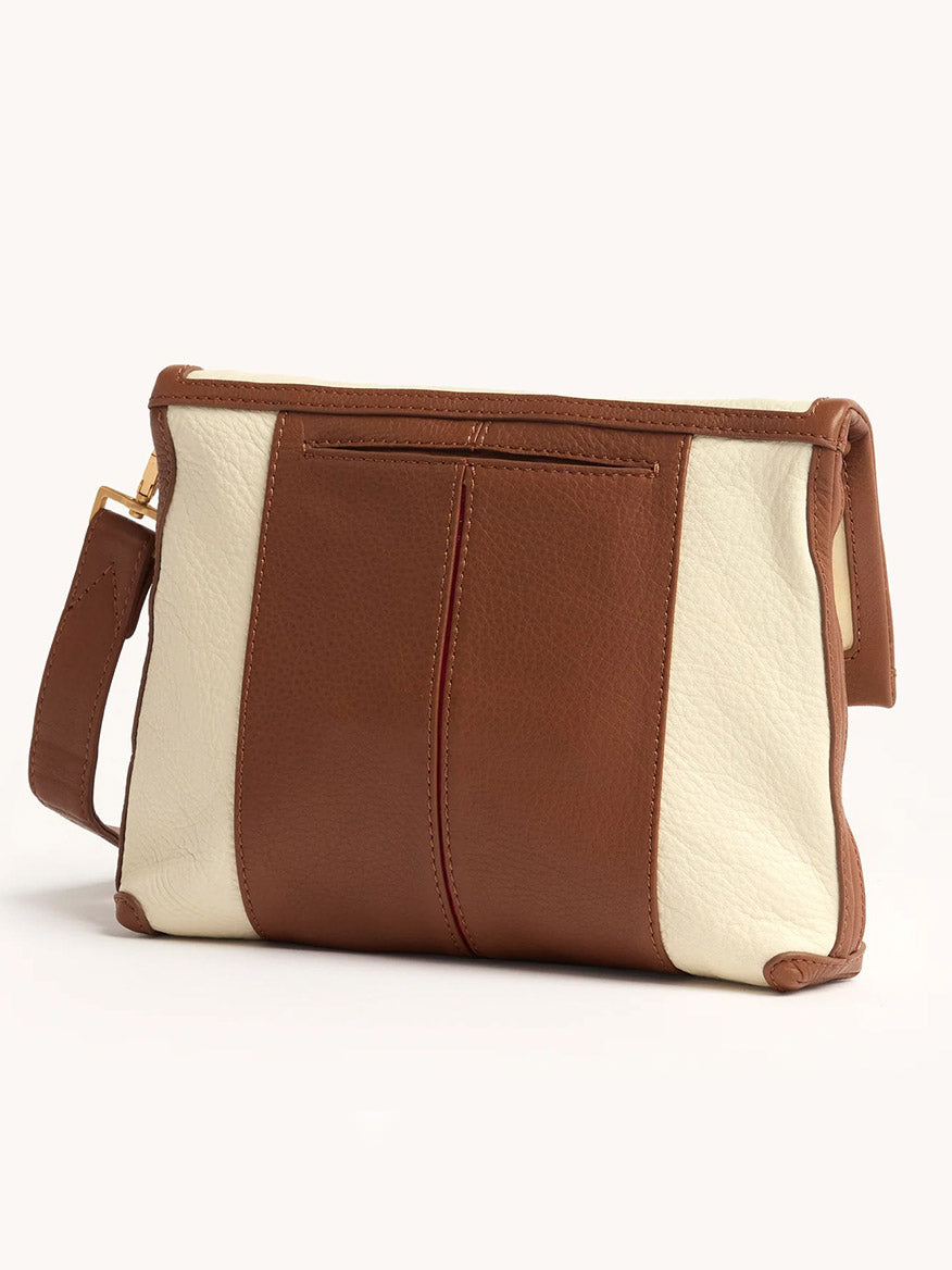 The Hammitt Los Angeles VIP Medium Clutch in Courtyard Cream features brown and cream leather, a wide detachable strap, gunmetal rivets, and an exterior zip pocket, shown on a plain light background.