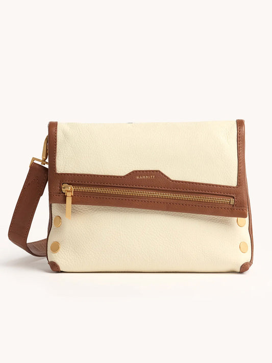 The Hammitt Los Angeles VIP Medium Clutch in Courtyard Cream features a cream and brown design, front zipper pocket, gold hardware, and an adjustable strap, shown against a plain light background.