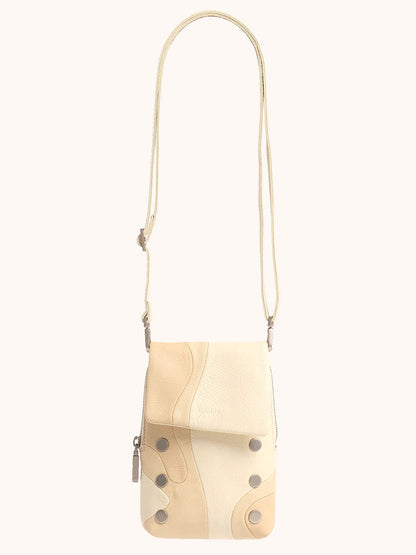 The Hammitt Los Angeles VIP Mobile in Coastal Cream is a crossbody bag featuring a long strap, flap closure, and metal button accents.