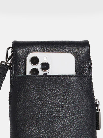 A Hammitt Los Angeles VIP Mobile in Black with three camera lenses peeked out from a black pebbled leather pouch with a zipper.