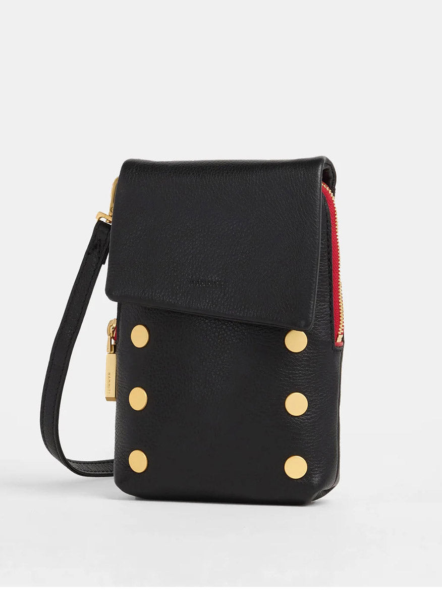 The Hammitt Los Angeles VIP Mobile in Black, with Brushed Gold and a Red Zip, is a black pebbled leather shoulder bag featuring a flap closure. It includes gold-tone accents and converts into a chic crossbody with its detachable strap for versatile styling.