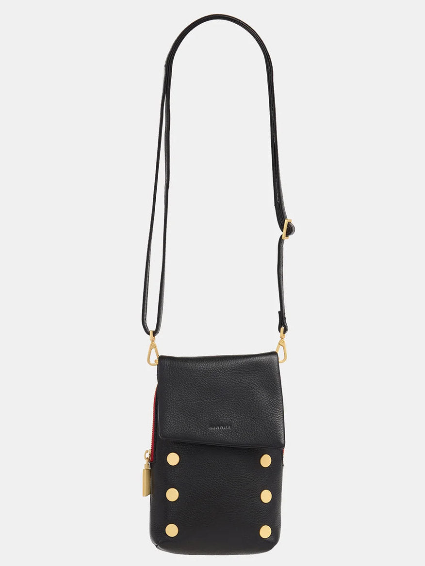 The Hammitt Los Angeles VIP Mobile in Black, Brushed Gold & Red Zip is a pebbled leather crossbody bag with gold button accents and an adjustable, detachable strap for versatile styling.