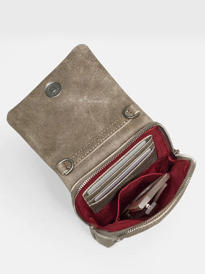 An open Hammitt Los Angeles VIP Mobile in Pewter leather wallet with a metallic clasp, revealing a red interior with cards and a zipper compartment.