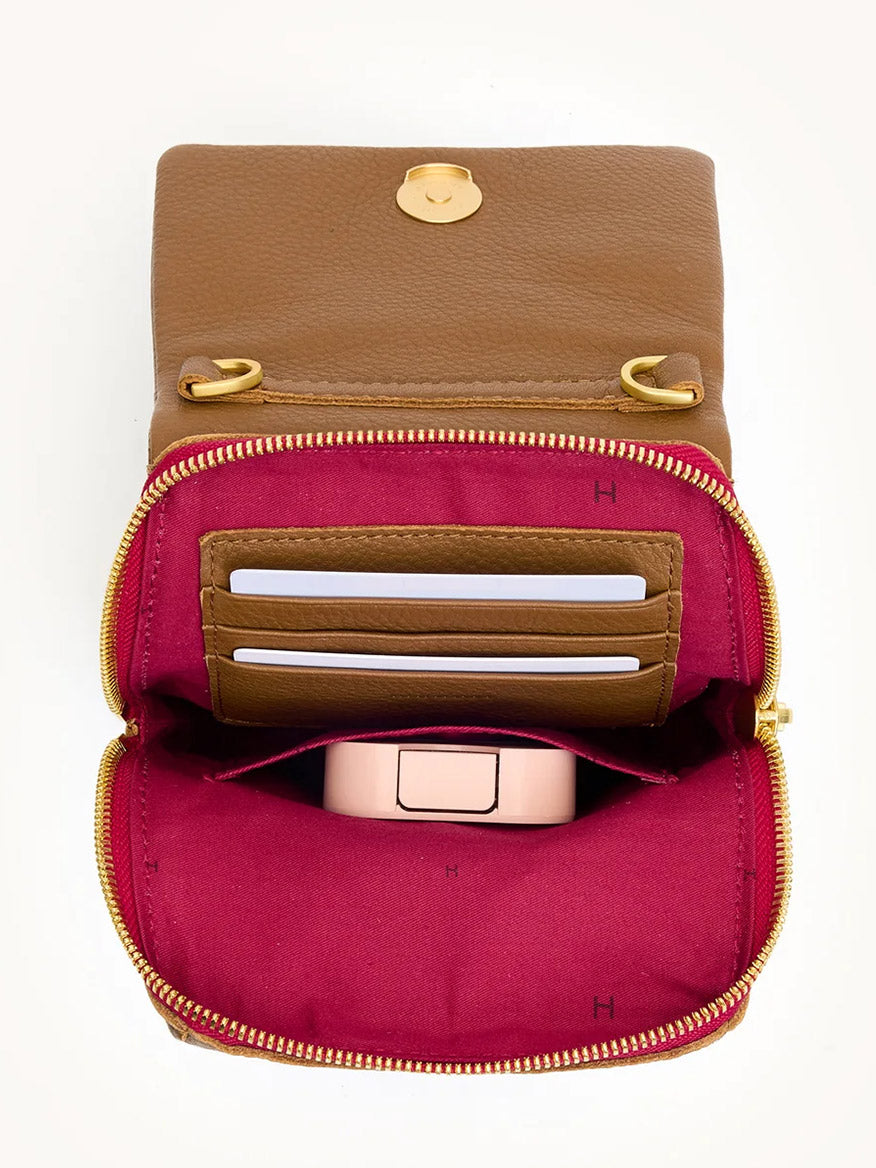 Open mahogany pebbled leather wallet with brushed gold zipper and clasp, showing three cards in slots and a small pink item in the red-lined compartment—perfect match for your Hammitt Los Angeles VIP Mobile.