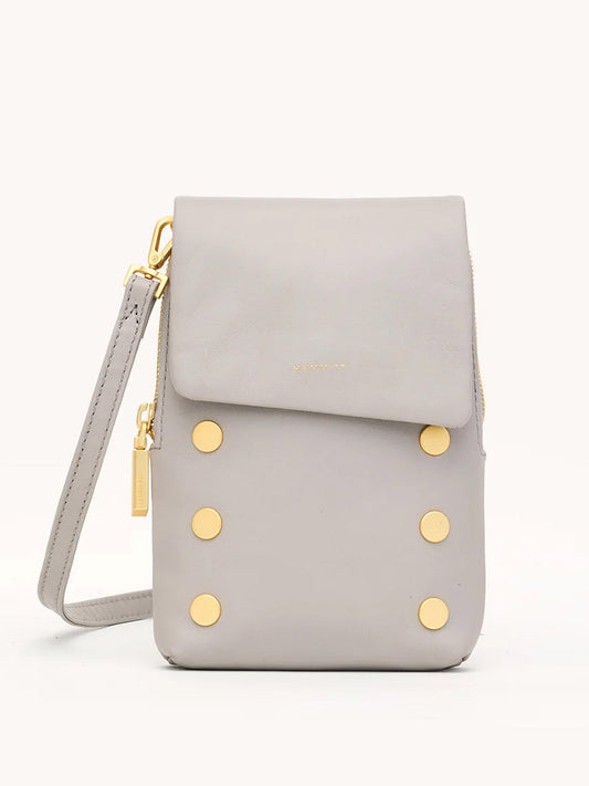 The Hammitt Los Angeles VIP Mobile in Stormy/Brushed Gold is a light gray pebble leather crossbody with gold studs, flap closure, wrist strap, and a small gold logo on the front.