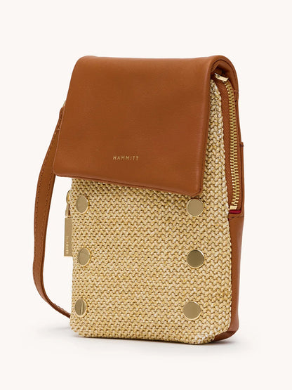 The Hammitt Los Angeles VIP Mobile in Cocoa Raffia/Gold is a small crossbody bag with a brown pebbled leather flap, beige woven front, gold studs and zipper, and "Hammitt" embossed on the flap.