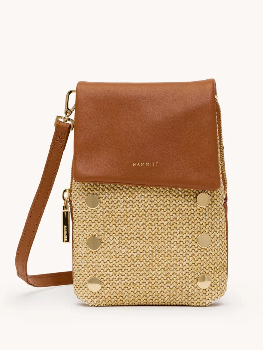 The Hammitt Los Angeles VIP Mobile in Cocoa Raffia/Gold is a chic crossbody with a tan pebbled leather flap, gold accents, woven straw body, gold hardware, and a detachable strap.