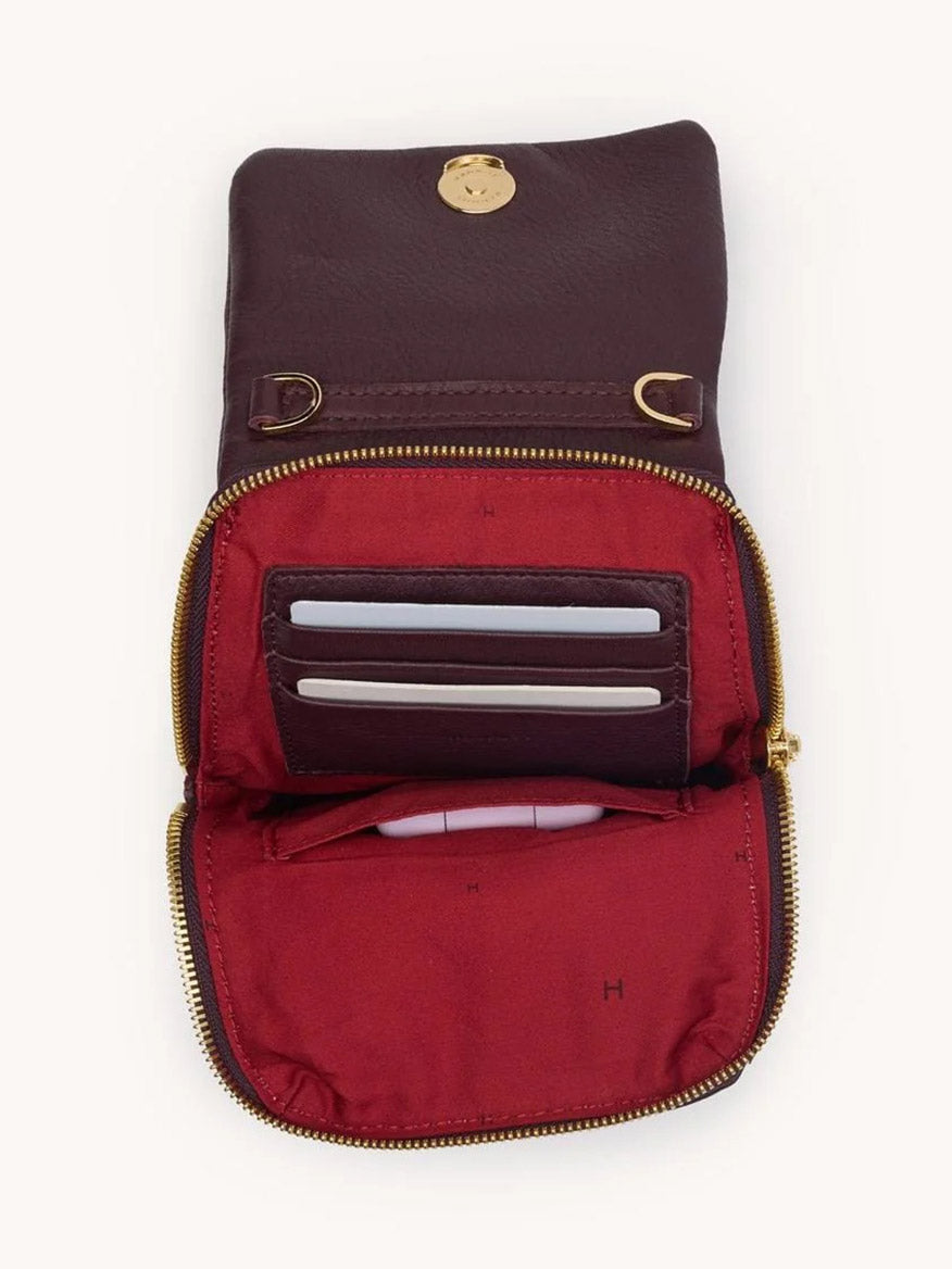 The Hammitt Los Angeles VIP Mobile in Regatta Stripe/Gold features a gold zipper and button, reveals a red-lined interior with card slots and compartments, and matches your favorite crossbody for effortless style.