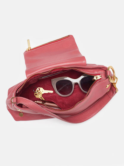 Open Hammitt Los Angeles VIP Satchel in Rouge Pink with a crossbody strap, sunglasses, and a set of keys inside, isolated on a white background.