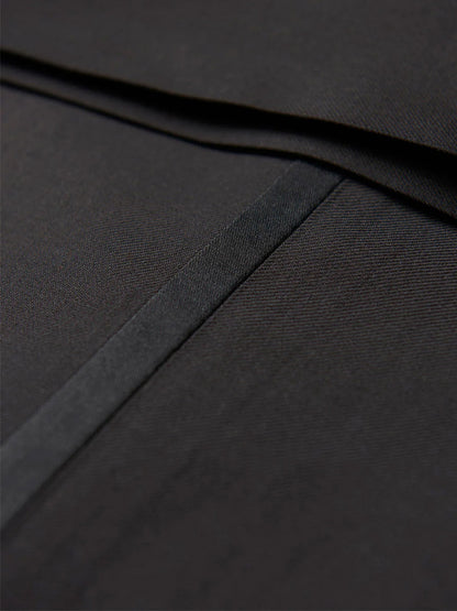 Close-up of a black fabric with delicate stitching and a subtle sheen, reminiscent of the luxurious craftsmanship seen in the Hickey Freeman (Heritage Gold) Black Peak Lapel B-Body Tuxedo.
