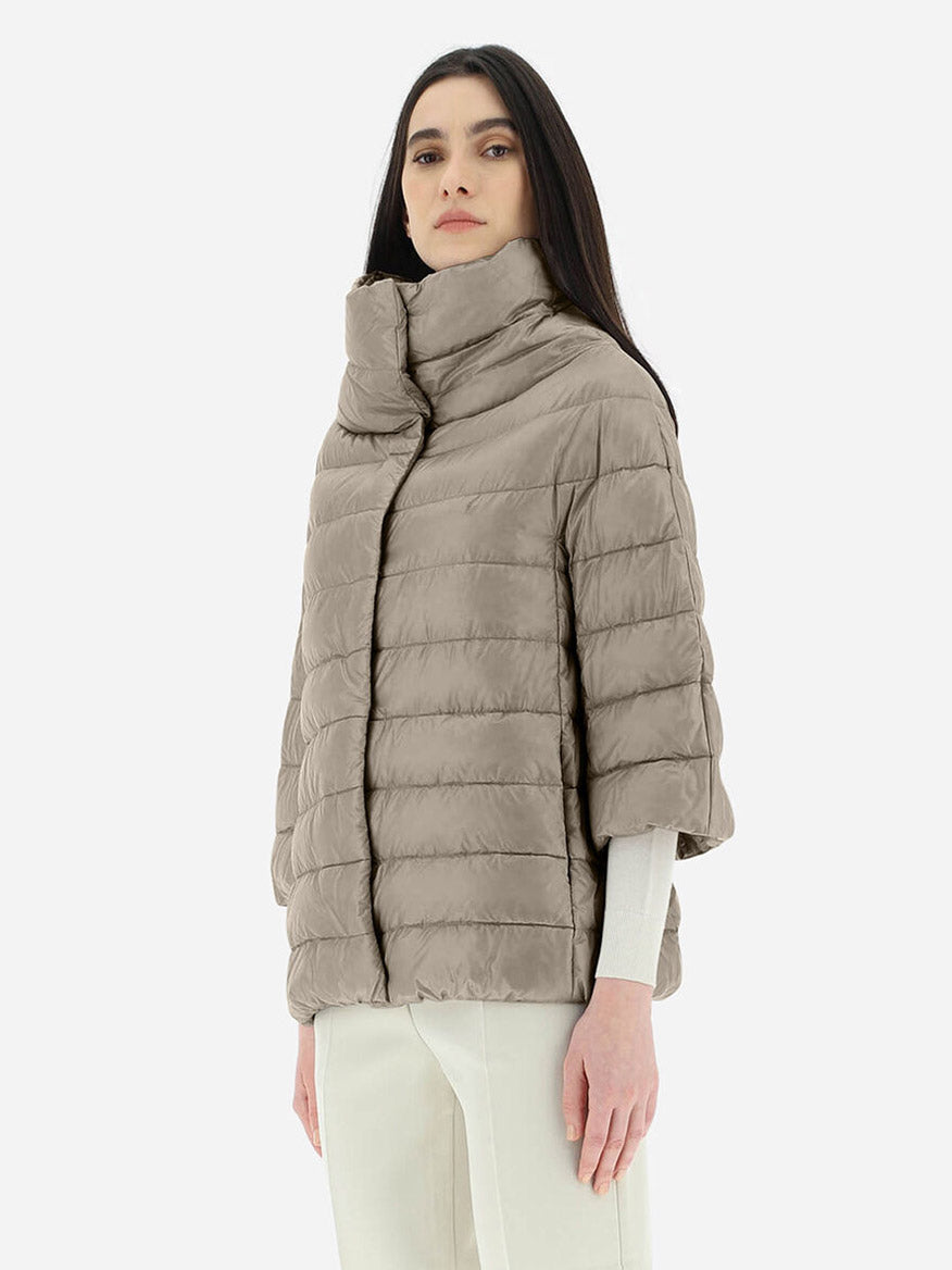 A woman in a Herno Aminta 3/4 Sleeve Cocoon Jacket in Taupe.