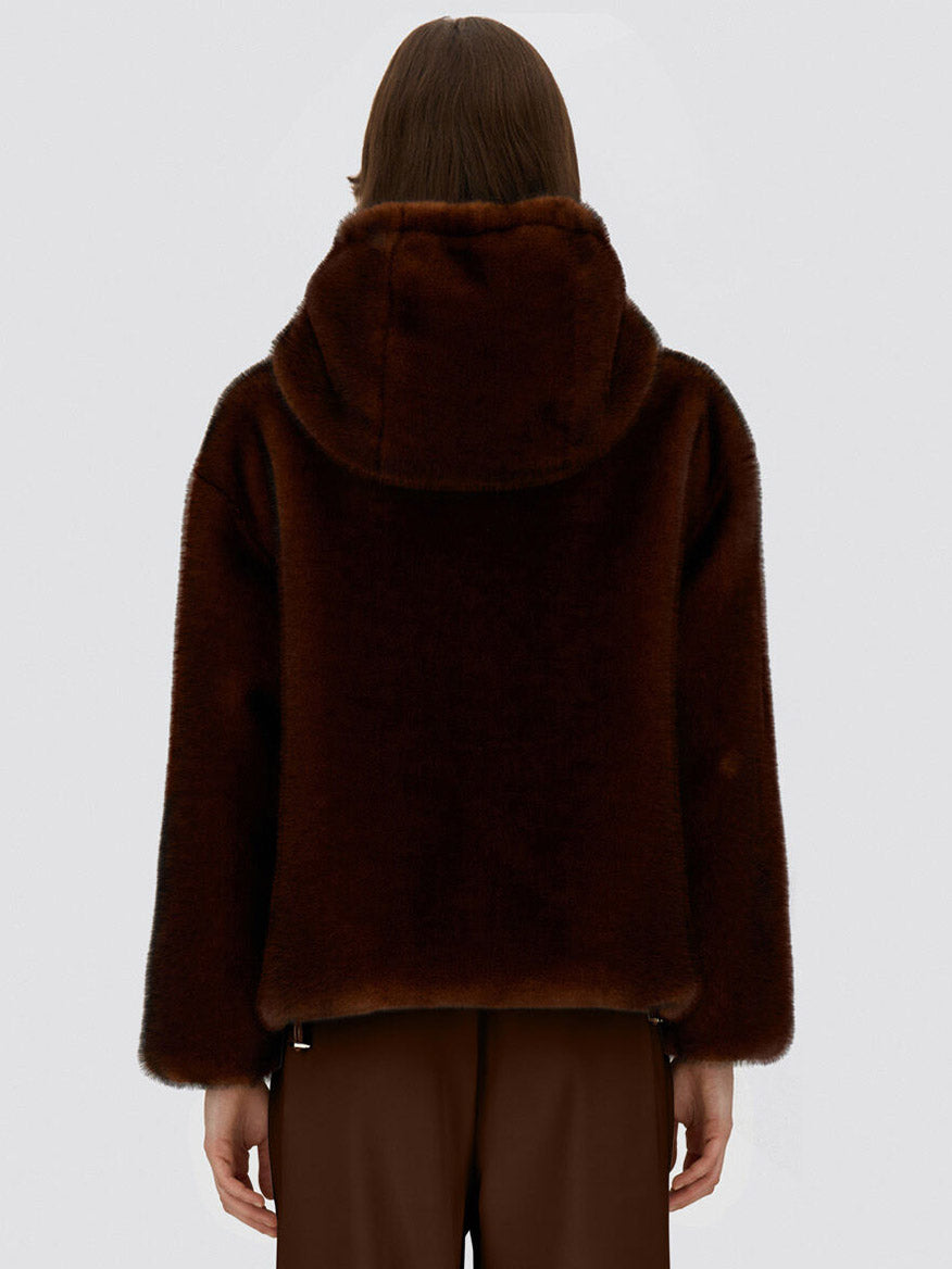 An individual wearing the Herno Bomber Jacket With Melange Alternative Mink Fur in Chocolate and brown pants, shown from the back against a plain light background.