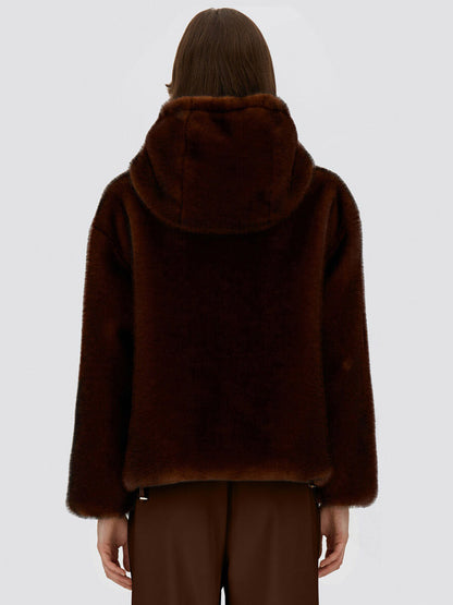 An individual wearing the Herno Bomber Jacket With Melange Alternative Mink Fur in Chocolate and brown pants, shown from the back against a plain light background.
