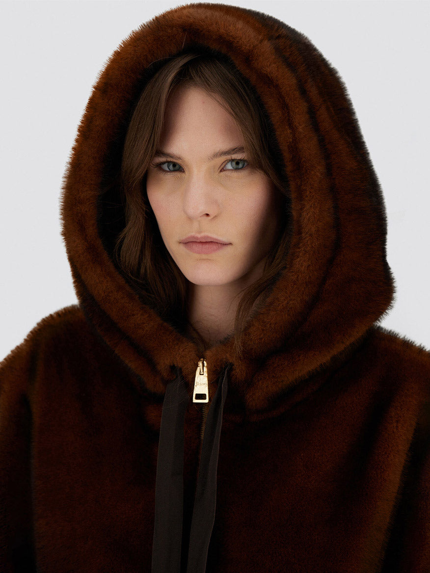 A woman wearing the Herno Bomber Jacket with melange alternative mink fur in chocolate, looking directly at the camera.
