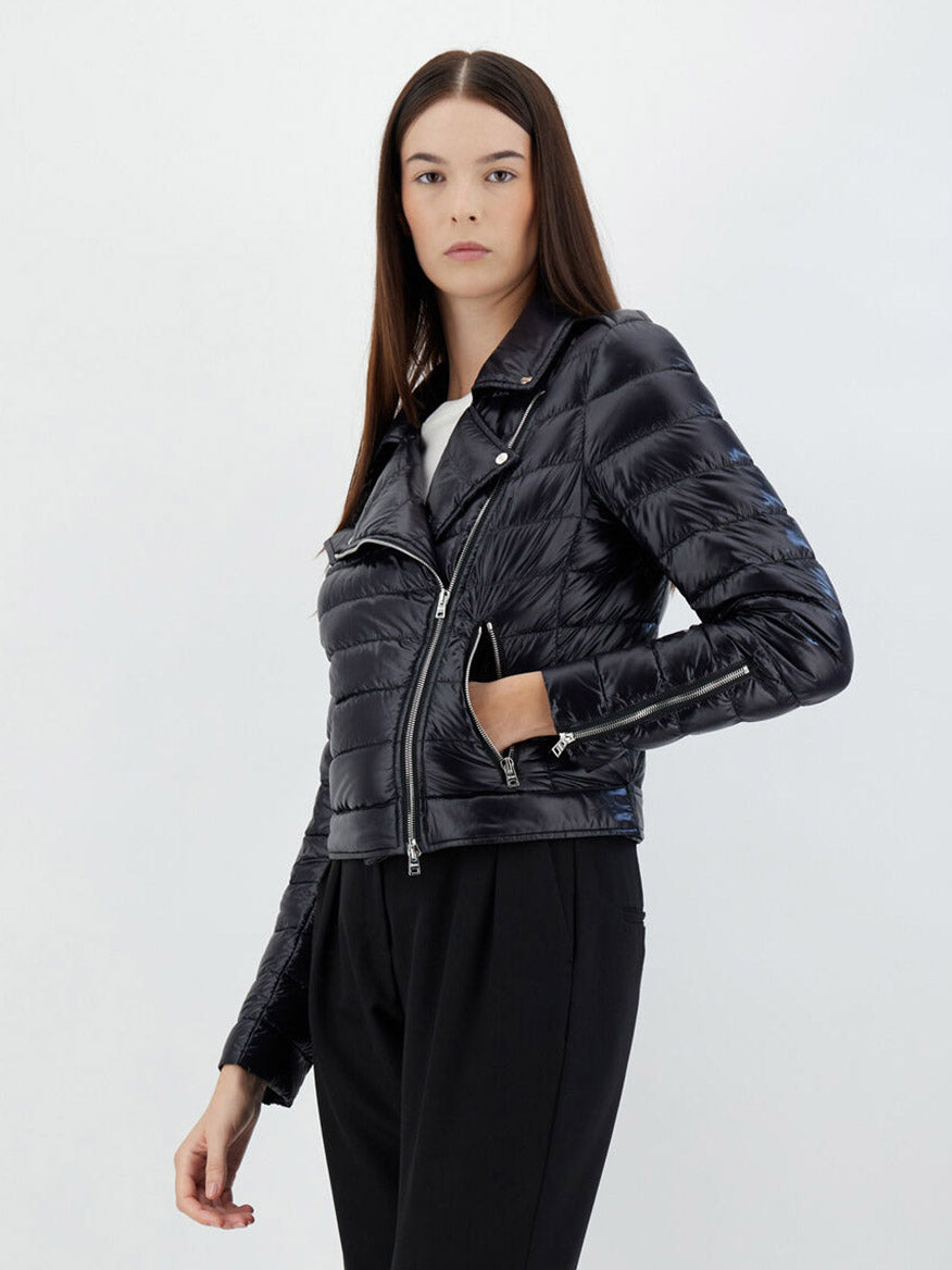 Woman modeling a Herno Bomber Jacket in Ultralight Nylon in Black with zipper detail and black trousers against a plain background.