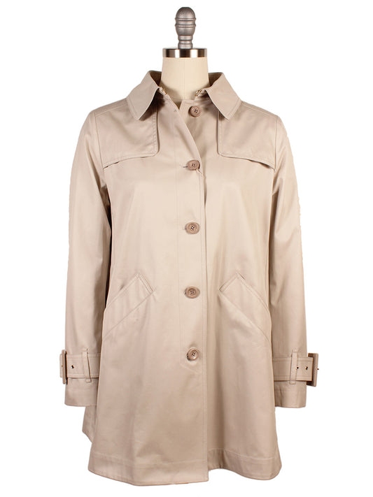 The Herno Delon and Monogram Trench Coat in Champagne, showcased on a mannequin, is made from cotton gabardine. It includes a collar, button closure, two front pockets, adjustable cuffs, and has a water-repellent coating for practicality.