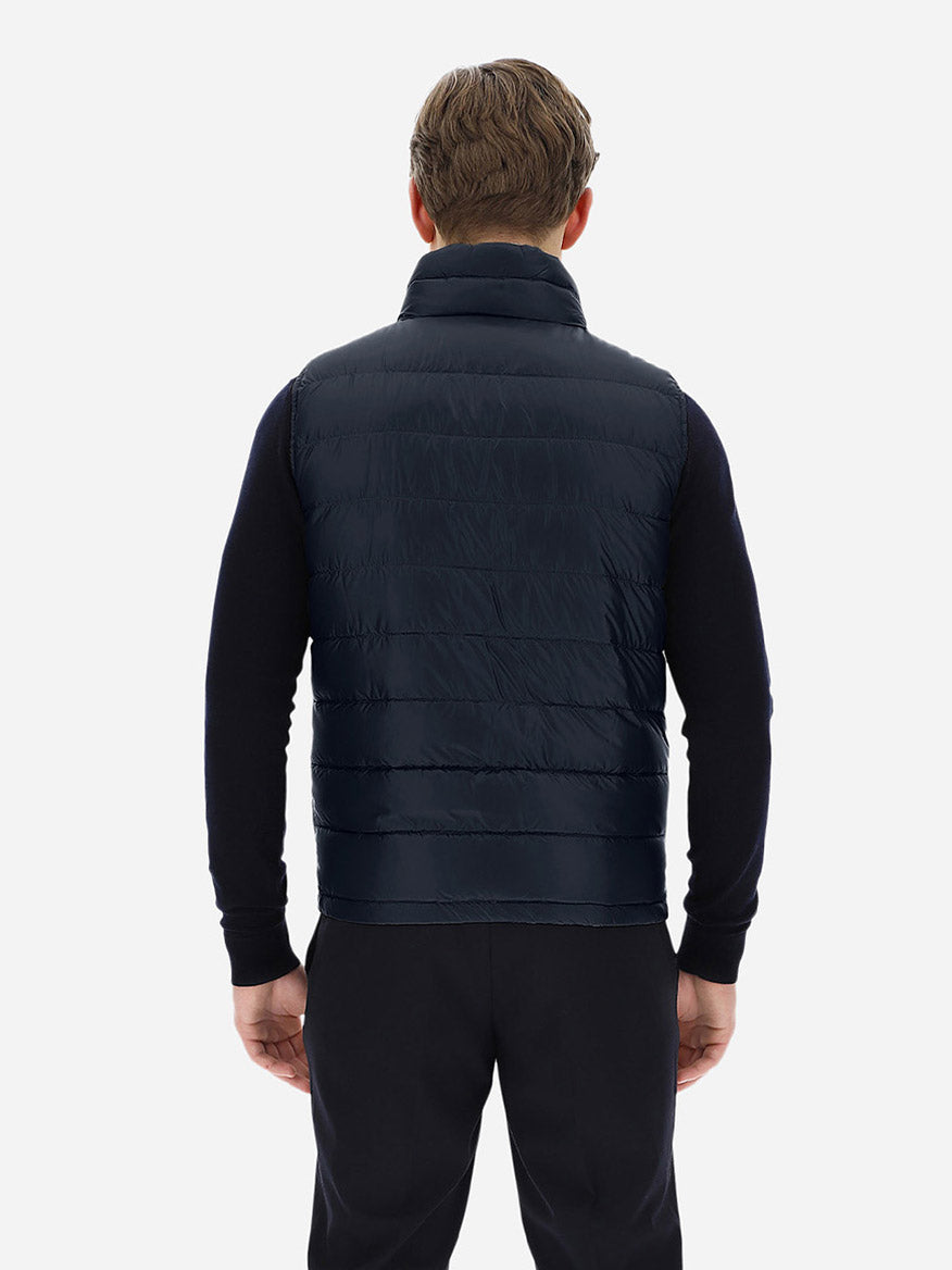 The back view of a man wearing a Herno Reversible Nylon Ultralight Waistcoat in Navy/Grey.
