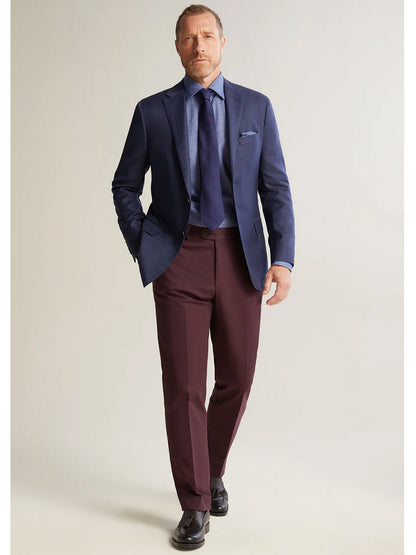 An American-made man in a Heritage Gold Navy Hopsack Global Guardian Blazer and burgundy tie.