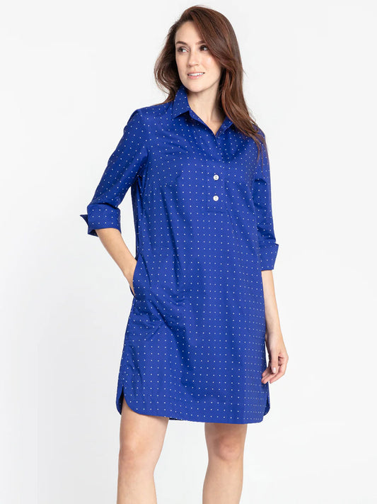 A woman in a Hinson Wu Aileen Dot Print Dress in Marine Dot Print poses with her hand on her hip, against a navy white background.