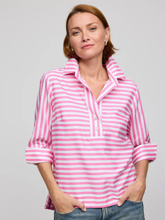 A woman confidently stands with her hands in her pockets, wearing a Hinson Wu Aileen 3/4 Sleeve Stripe/Check Combo Top in Guava/White against a plain background.