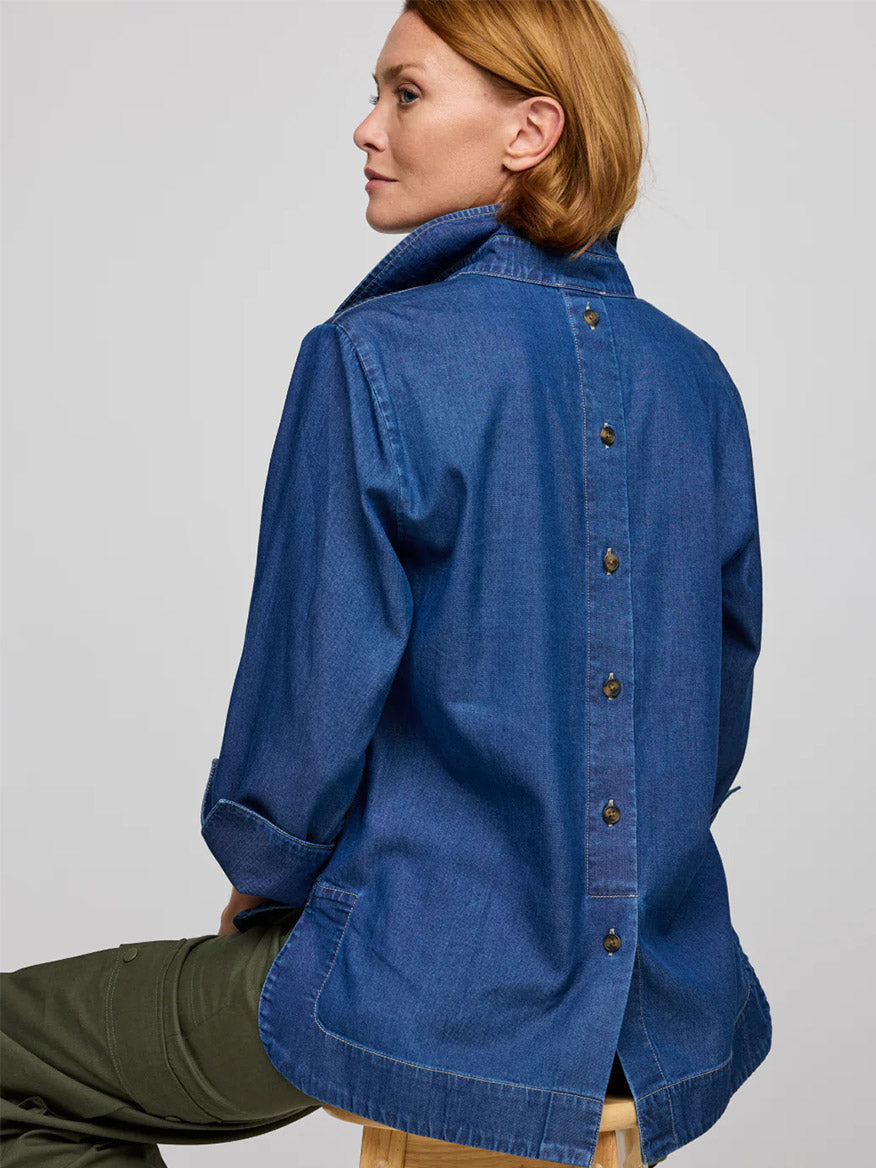 Sitting on a stool, facing away, the person is wearing a Hinson Wu Aileen 3/4 Sleeve Denim Shirt in Dark Wash.