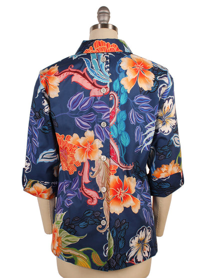 The back view of the Hinson Wu Aileen 3/4 Sleeve Floral Shirt in Oasis reveals a navy-blue shirt decorated with orange, yellow, and blue flowers. Made from a cotton stretch blend, it includes a collar and three-quarter sleeves for an elegant appearance.