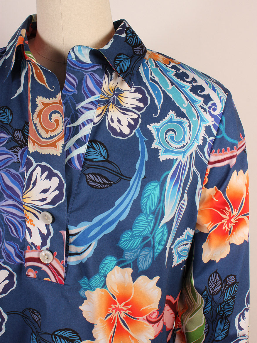 The mannequin displays the Hinson Wu Aileen 3/4 Sleeve Floral Shirt in Oasis, a blue top made from a cotton stretch blend. It features a polished floral and abstract pattern with large orange and white flowers.