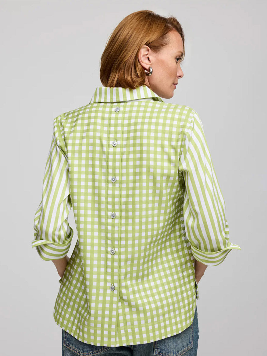 A person with short light brown hair wears the Hinson Wu Aileen 3/4 Sleeve Stripe/Gingham Combo Dress in Lime/White, a 100% cotton dress with checkered and striped patterns, paired with blue jeans.