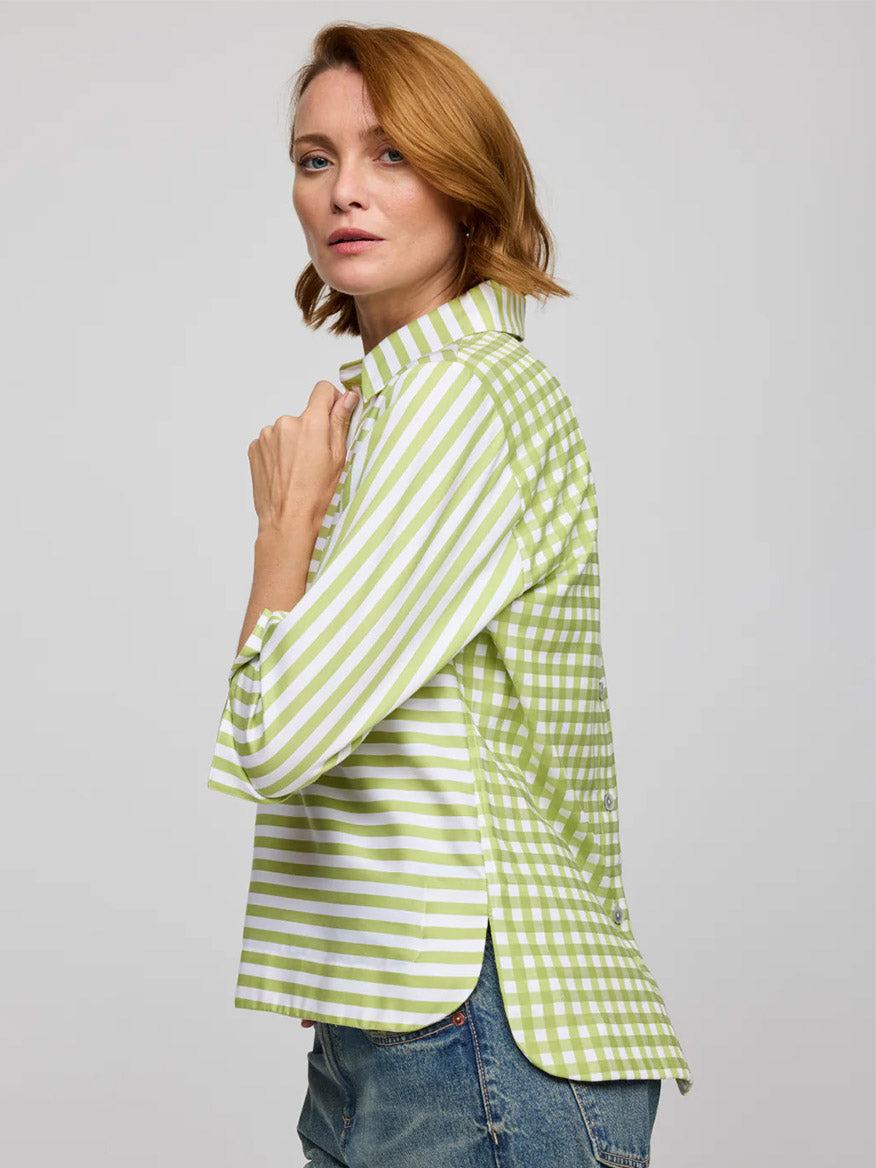 Woman standing sideways in the Hinson Wu Aileen 3/4 Sleeve Stripe/Gingham Combo Dress in Lime/White, looking at the camera against a plain background for a polished look.