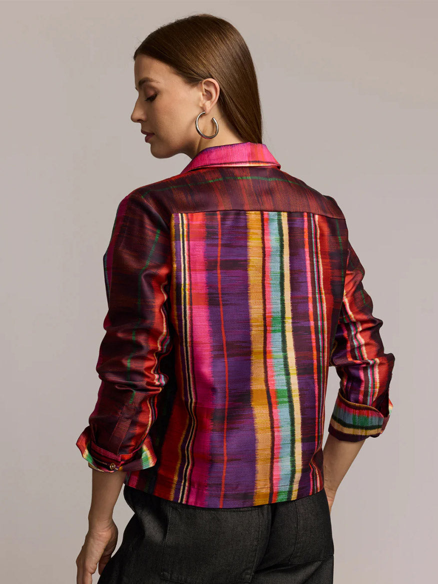 A woman is seen from the back wearing the Hinson Wu Astrid Long Sleeve Textured Stripes Shirt in Multi, featuring vibrant textured stripes, paired with dark pants against a neutral background.