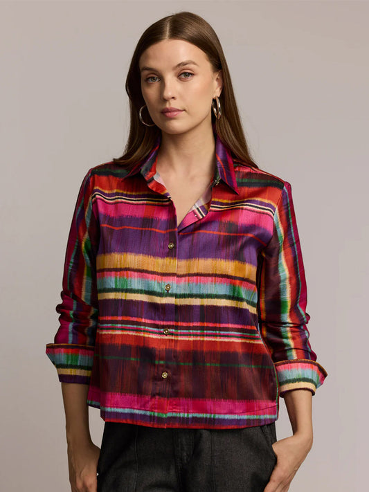 Woman wearing the Hinson Wu Astrid Long Sleeve Textured Stripes Shirt in Multi—a colorful, striped cotton-blend shirt—paired with dark pants, standing against a plain, light background.