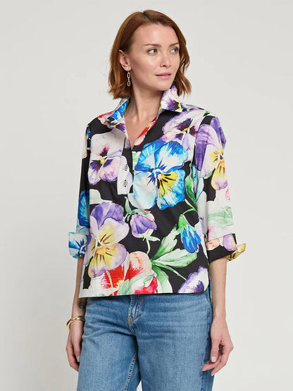 A woman wearing the Hinson Wu Charlotte 3/4 Sleeve Pansy Print Top, paired with blue jeans, stands against a light background.