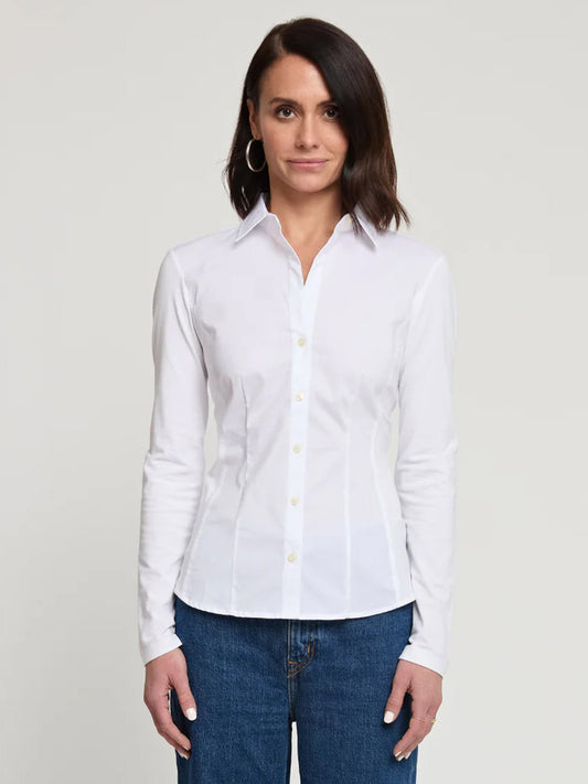 A woman faces forward against a plain light background wearing the Hinson Wu Jamie Long Sleeve "T" Shirt in White and blue jeans.