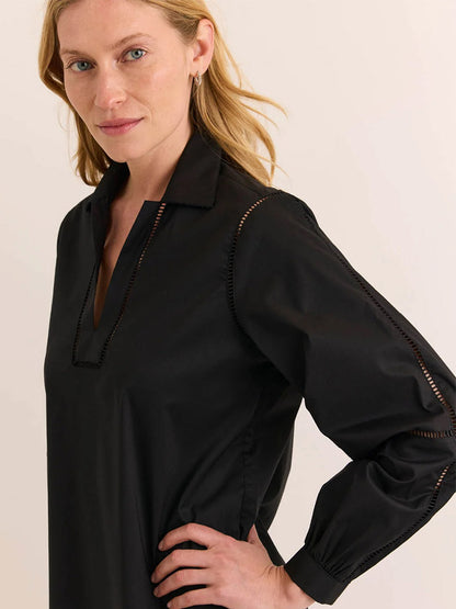 A woman with light blonde hair wears the Hinson Wu Laura Long Sleeve Lace Trim Dress in Black, featuring a V-neck and ladder-stitch detailing along the neckline and sleeves, set against a plain light background.