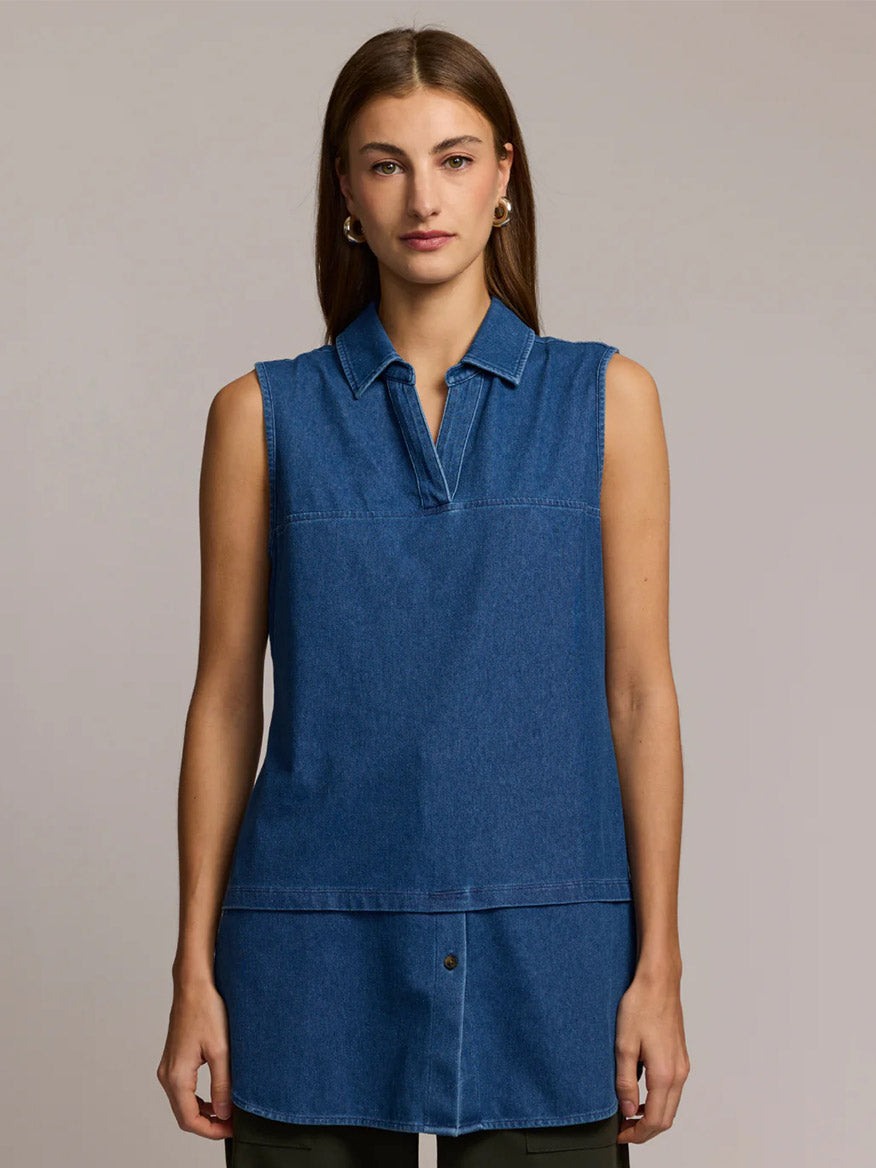 A woman faces forward, wearing the Hinson Wu Lea Sleeveless Knit Denim Foundation Layer in Medium Wash, featuring a collar and front seam detail, set against a plain neutral background.