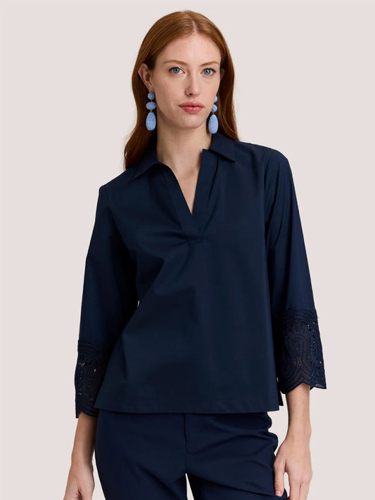 Model wearing the Hinson Wu Mona Bracelet Sleeve Lace Top in Navy, featuring lace details and soft stretch cotton-blend fabric, paired with matching navy pants, posed against a plain light background.