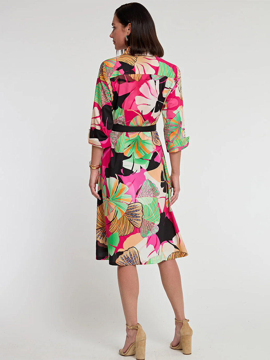 Woman facing away, wearing a colorful Hinson Wu Tamron 3/4 Sleeve Dress in Gingko Print with beige high heels, standing against a plain white background.