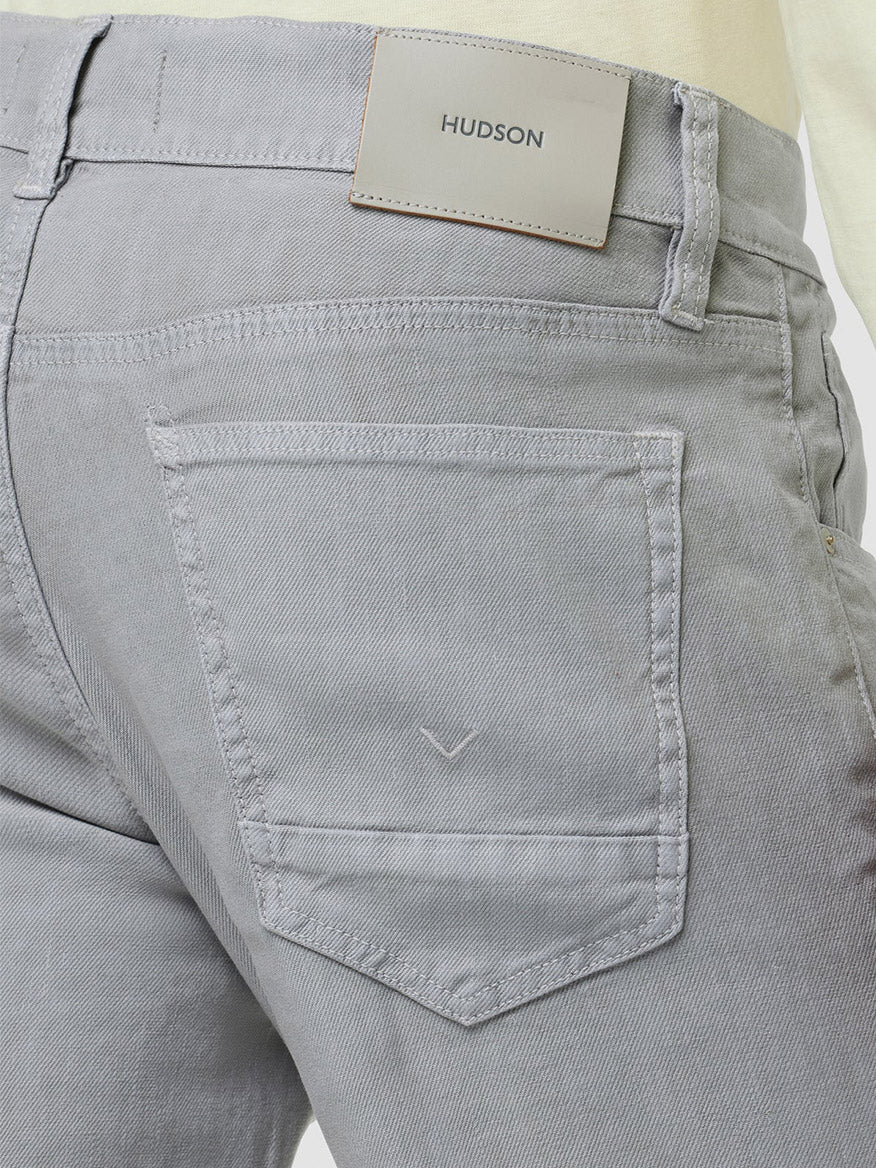 Close-up of a grey Hudson Blake Slim Straight Twill Jean in Cement trouser pocket detail with tapered leg.