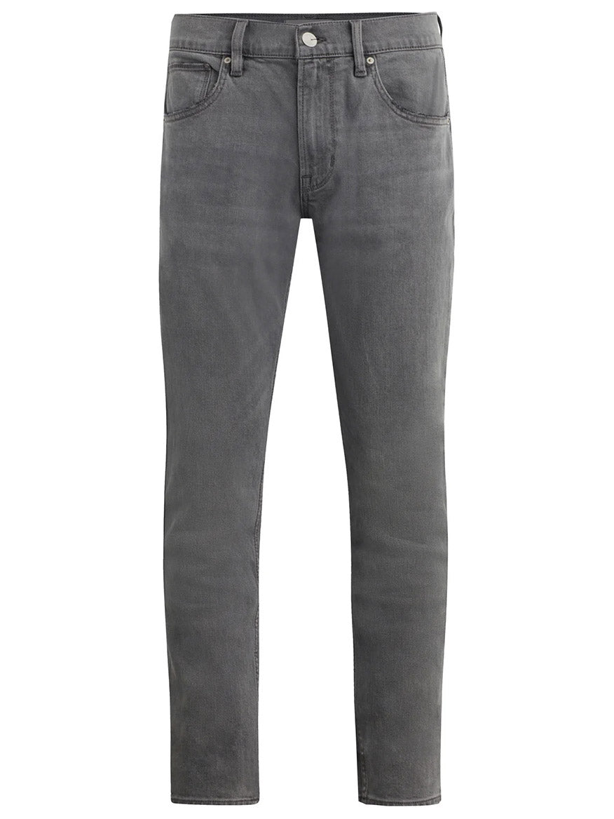 Hudson Blake Slim Straight Jeans in Moon Ridge offer a pair of gray denim jeans with a classic five-pocket design, button closure, and belt loops. They feature a mid-rise and tapered leg for a slim fit.