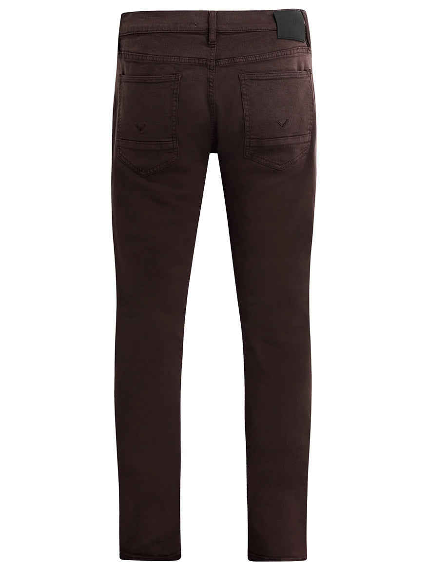 Back view of the Hudson Blake Slim Straight Jeans in Timber, featuring two back pockets and a leather patch on the waistband, elegantly finished in a stylish dark brown wash.