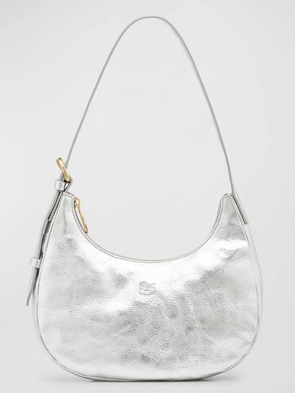 A Il Bisonte Belcanto Shoulder Bag in Metallic Silver handmade in Tuscany, crescent-shaped with a single strap and zipper closure, featuring a small decorative knot on one side.