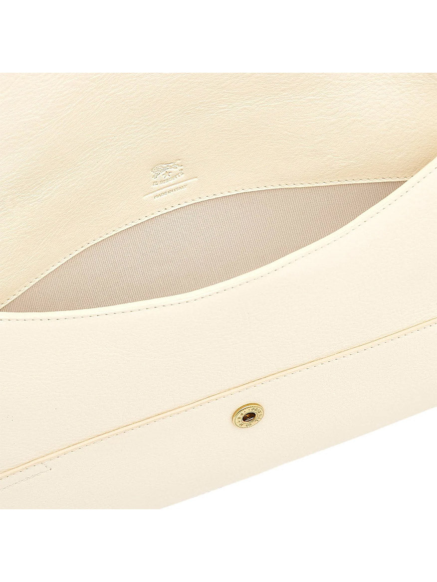 Close-up of the interior of the Il Bisonte Esperia Clutch in White Cowhide Leather, meticulously handcrafted in Tuscany from beige vegetable-tanned leather, featuring a snap button closure and a subtle embossed logo.