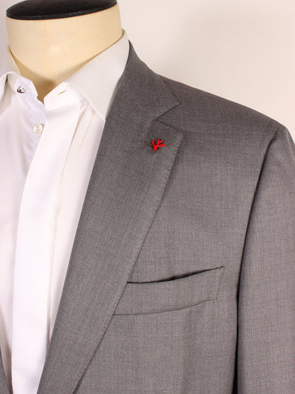 A close-up of a mannequin dressed in a light gray, tailored suit jacket with a white dress shirt underneath. A red pin is attached to the lapel of the Isaia AquaSpyder 160s Wool Suit in Solid Medium Grey, proudly Made in Italy.