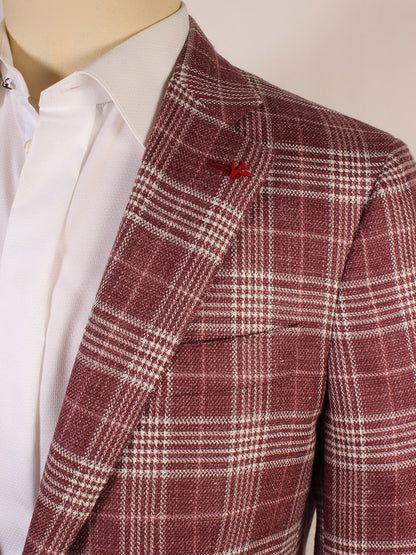 Close-up of a person in a white dress shirt and the Isaia Sanita Plaid Sport Jacket in Burgundy Plaid, featuring a small red lapel pin. Made in Italy.