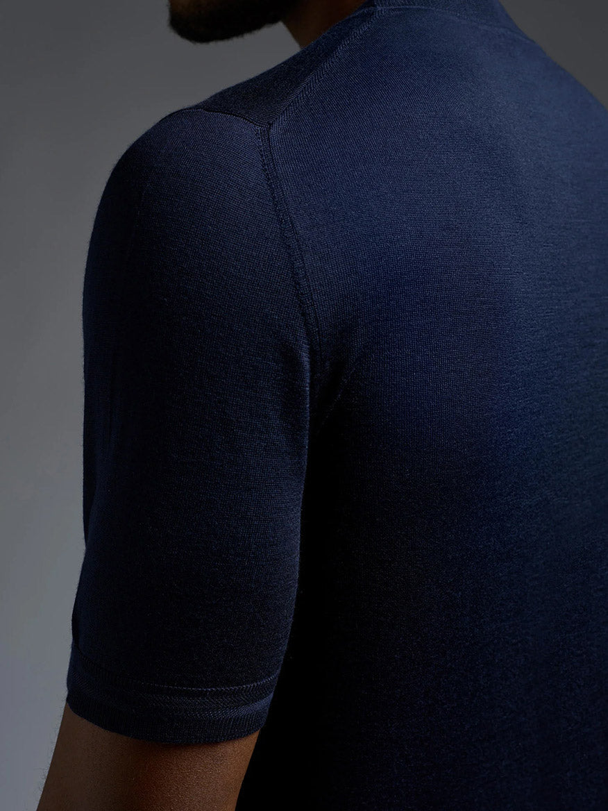 Close-up of a person wearing the Isaia Wool Cashmere Banded Tee in Navy, photographed from the back and slightly to the side.